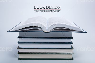 open book on a pile of books