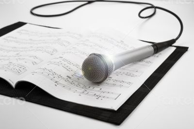 microphone lying on the musical book