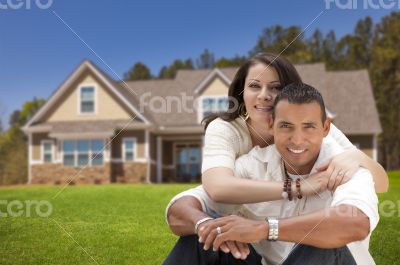 Happy Hispanic Young Couple in Front of Their New Home