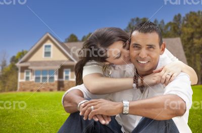 Happy Hispanic Young Couple in Front of Their New Home