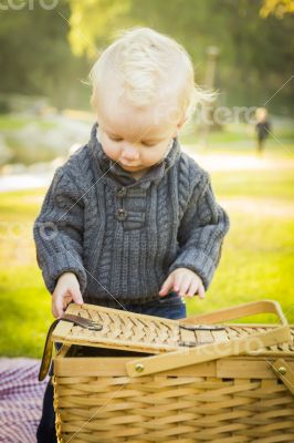 Blonde Baby Boy Opening Picnic Basket Outdoors at the Park