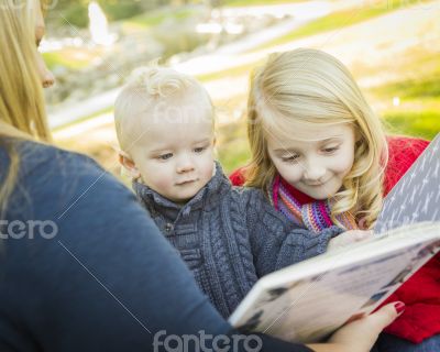 Mother Reading a Book to Her Two Adorable Blonde Children