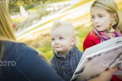 Mother Reading a Book to Her Two Adorable Blonde Children