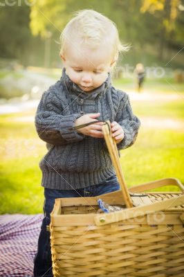 Blonde Baby Boy Opening Picnic Basket Outdoors at the Park