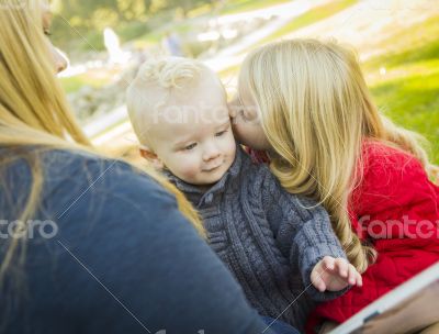 Mother Reading a Book to Her Two Adorable Blonde Children