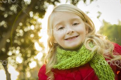 Little Girl Wearing Winter Coat and Scarf at the Park