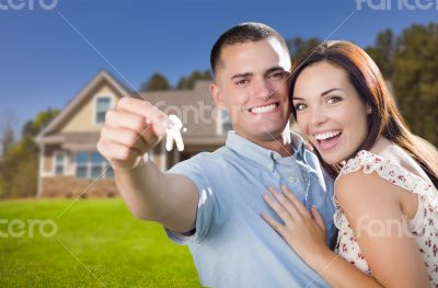 Military Couple with House Keys In Front of New Home