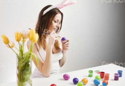 Girl painting easter eggs