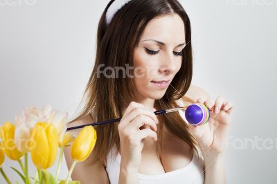 Girl painting easter eggs