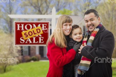 Family in Front of Sold Real Estate Sign and House