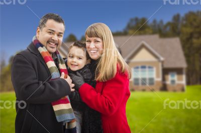 Happy Mixed Race Family in Front of House