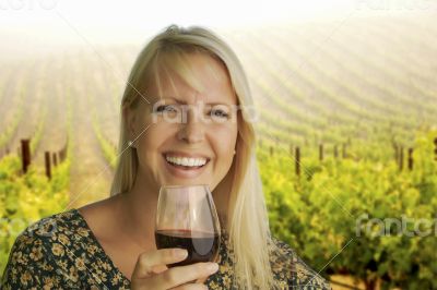 Attractive Woman Enjoying a Glass of Wine at the Vineyard