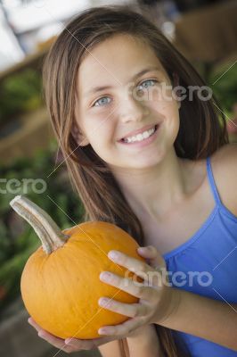 Pretty Young Girl Having Fun with the Pumpkins at Market