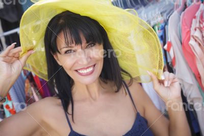Pretty Italian Woman Trying on Yellow Hat at Market