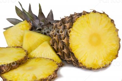 Pineapple and slices of pineapple on a white background.