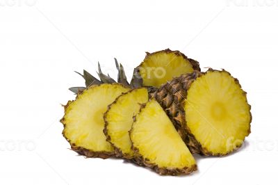 Pineapple and slices of pineapple on a white background.