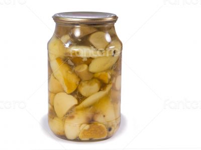 Canned mushrooms in a glass jar on a white background.
