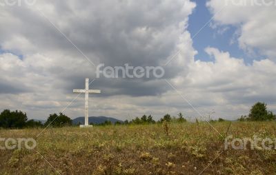 Old cross in the field.