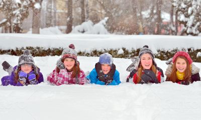 children on snow in winter time