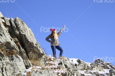 Young girl standing on a rock 