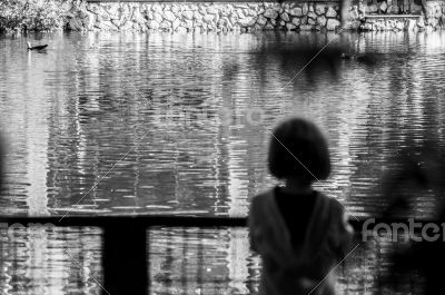 girl looks at the pond