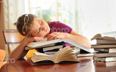 teenager girl sleeping on books