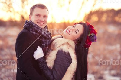 Happy young couple smiling and hugging