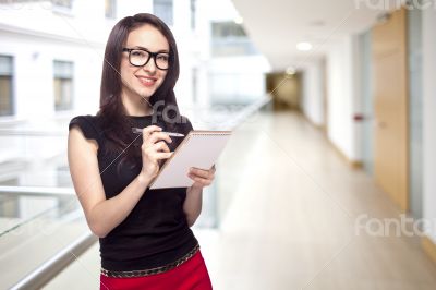 Girl in office with paper notepad