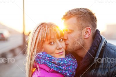 Young man kissing a beautiful woman