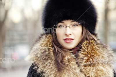 Woman wearing fur hat and glasses