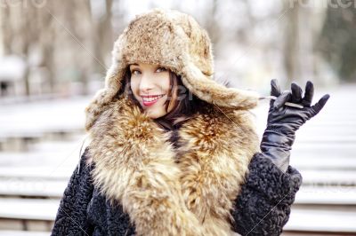 Joyfull russian woman in fur hat and coat