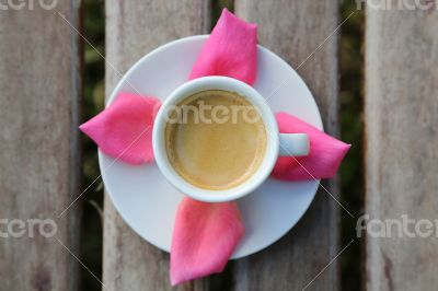 Cup of coffee on the wooden surface - top view