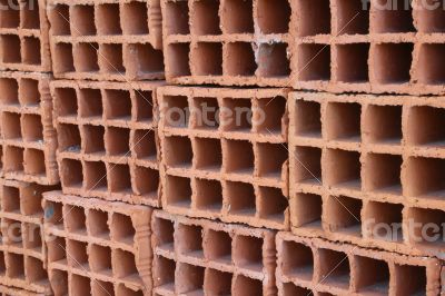 A row of hollow clay bricks - background