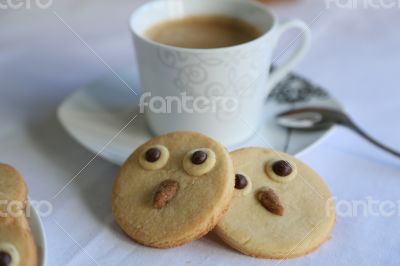Two owl biscuits and a cup of coffee