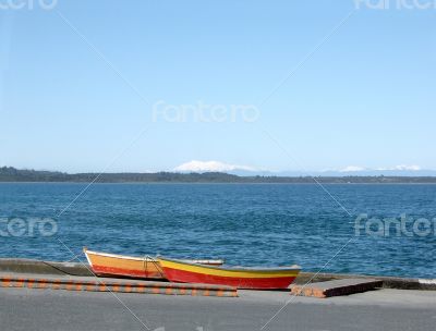 Two colorful fishermen`s boats in Puerto Montt