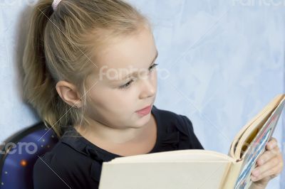 Cute girl reading a book