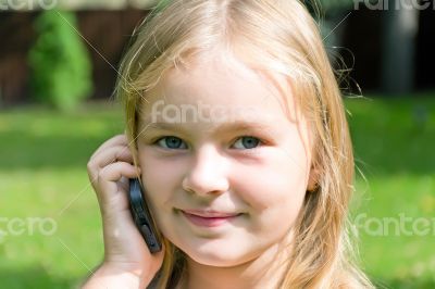 Cute girl talking by cellular