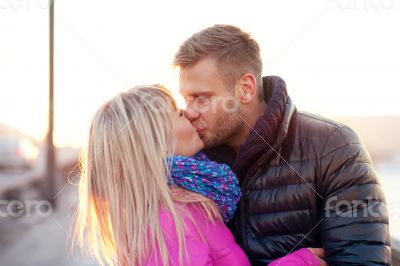 Couple kissing in winter warm clothes