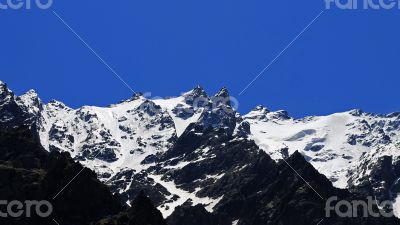 Caucasus mountains under snow and clear blue sky