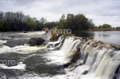 Threshold of the mountain river and wet stones 