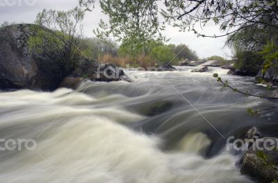 Threshold of the mountain river and wet stones 