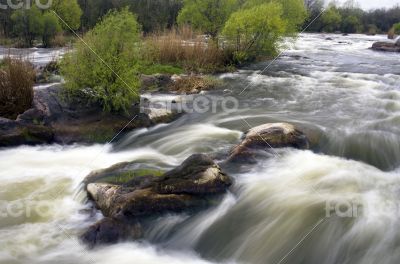 Threshold of the mountain river and wet stones 