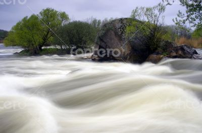 Threshold of the mountain river and wet stones 