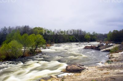 Threshold of the mountain river and wet stones 
