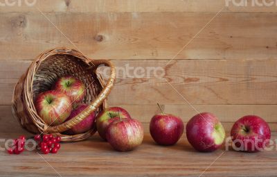 Apples in a basket on a wooden background