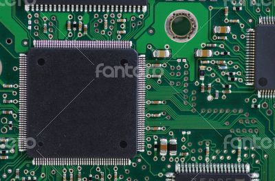 Green computer board with chips and components. 