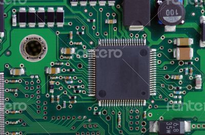 Green computer board with chips and components.