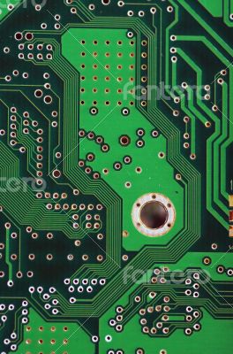 Green computer board with chips and components.