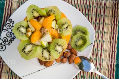 Fruit salad and a glass of fresh orange juice