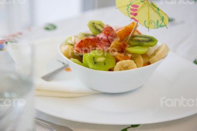 A white plate of fruit salad